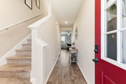 Foyer with wood-look floors and the staircase to the second floor