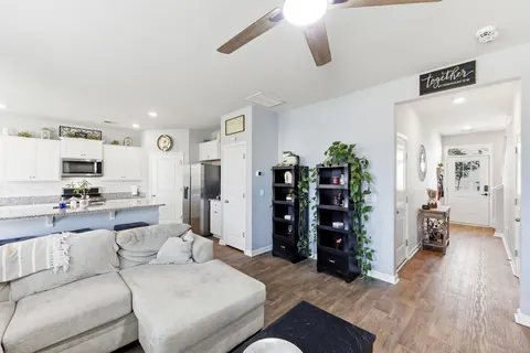 Open floor plan connecting the living room, kitchen, and foyer