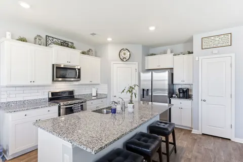 Kitchen with stainless steel appliances and a large island