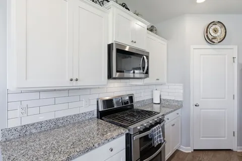 Gas range set against a subway tile backsplash