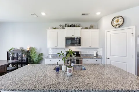 Granite island with breakfast bar seating
