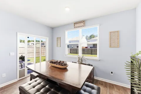Dining nook with backyard views and wood-look flooring