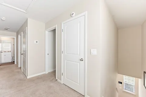 Upstairs landing and carpeted hallway