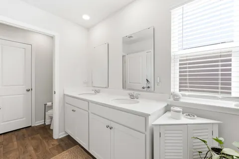 Primary bath with a double vanity and window