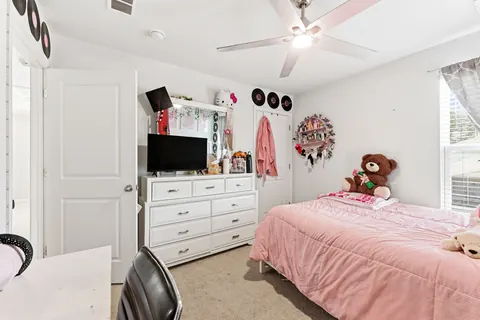 Secondary bedroom layout with a ceiling fan