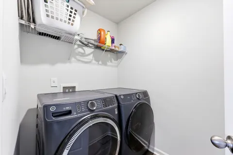 Upstairs laundry room with wire shelving