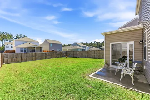 Back patio off the sliding door, overlooking the fenced yard