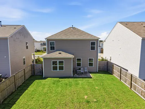Rear of the home with the patio and 6-foot wood privacy fence