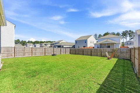 Wide open lawn in the fenced backyard