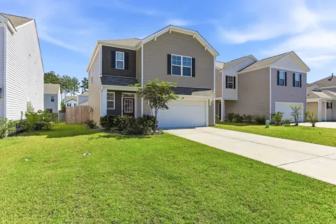 Front yard landscaping and red front door