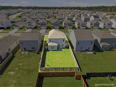 Aerial photo with approximate lot lines showing the fenced backyard