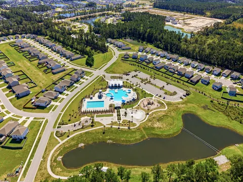 Aerial of the Pine Hills pool and clubhouse by the pond